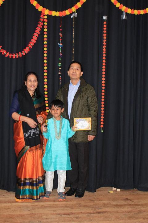A young performer receiving a certificate on stage