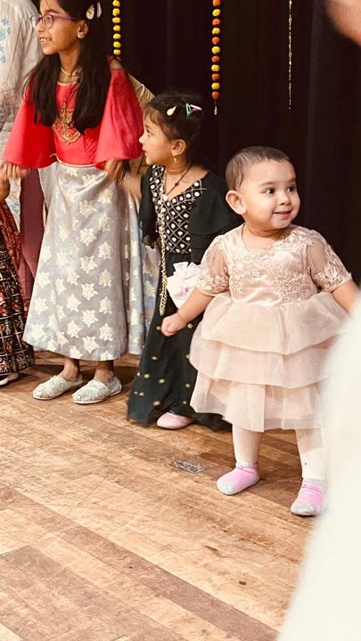 Young children in festive dress on the stage